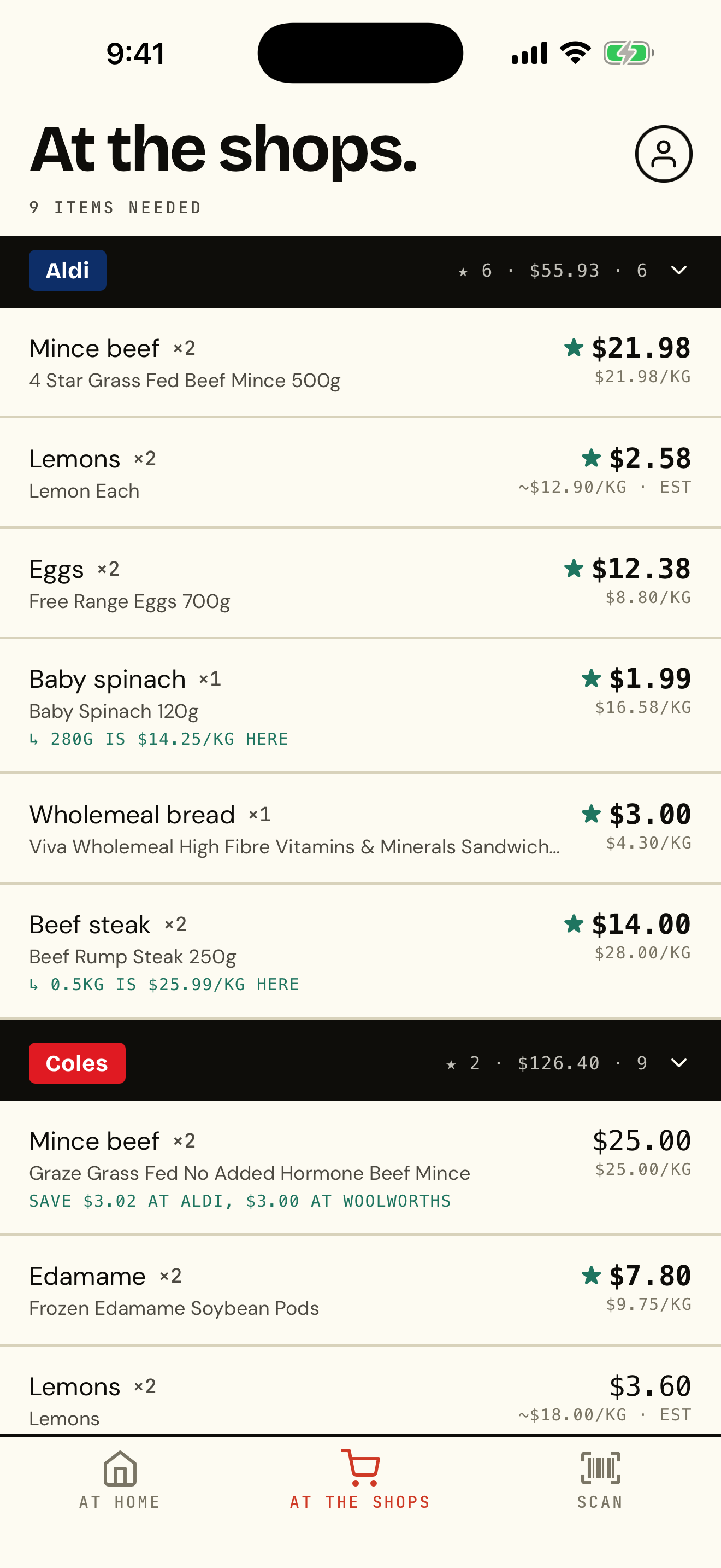 The Shops At the shops. tab listing groceries under the cheapest store for each — Aldi, Coles, Woolworths — with prices and per-kg unit prices.